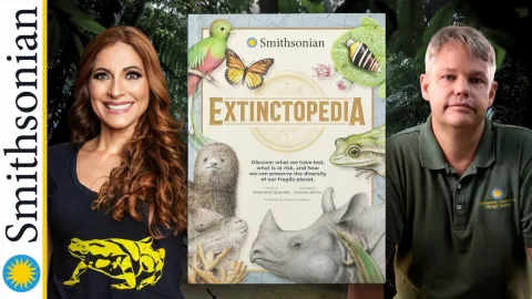 Two Smithsonian scientists next to their book "Extinctopedia"