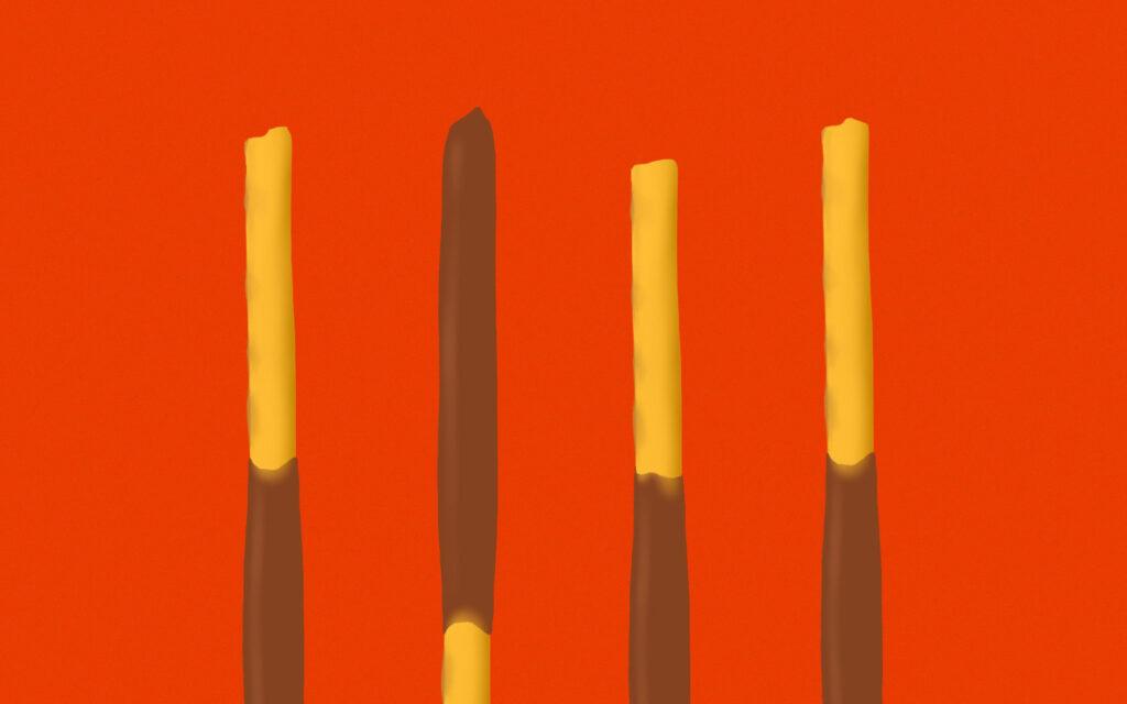 four pocky sticks with chocolate on one end